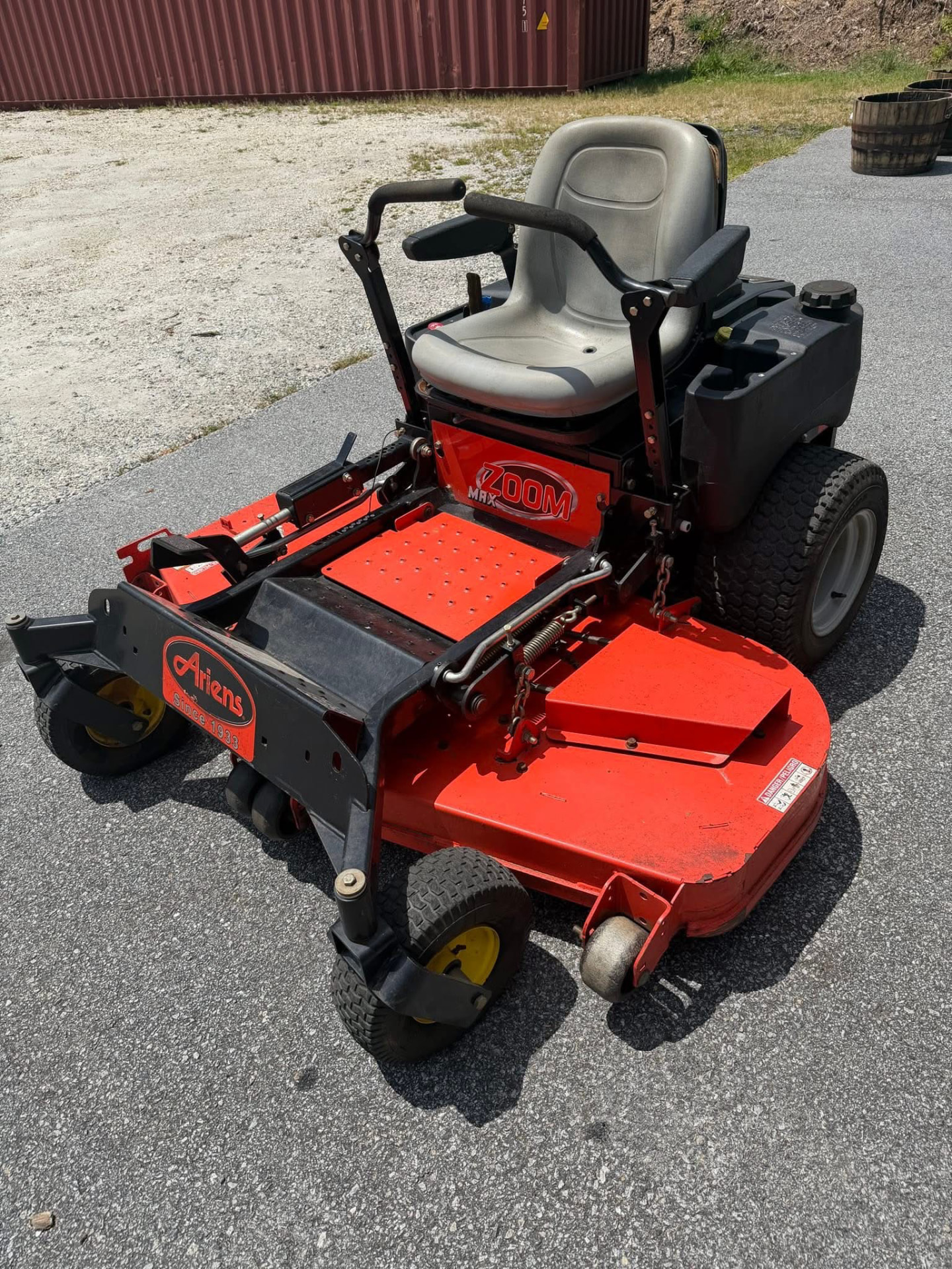 Red zero-turn riding lawn mower parked outside Austin's Home Supply & More