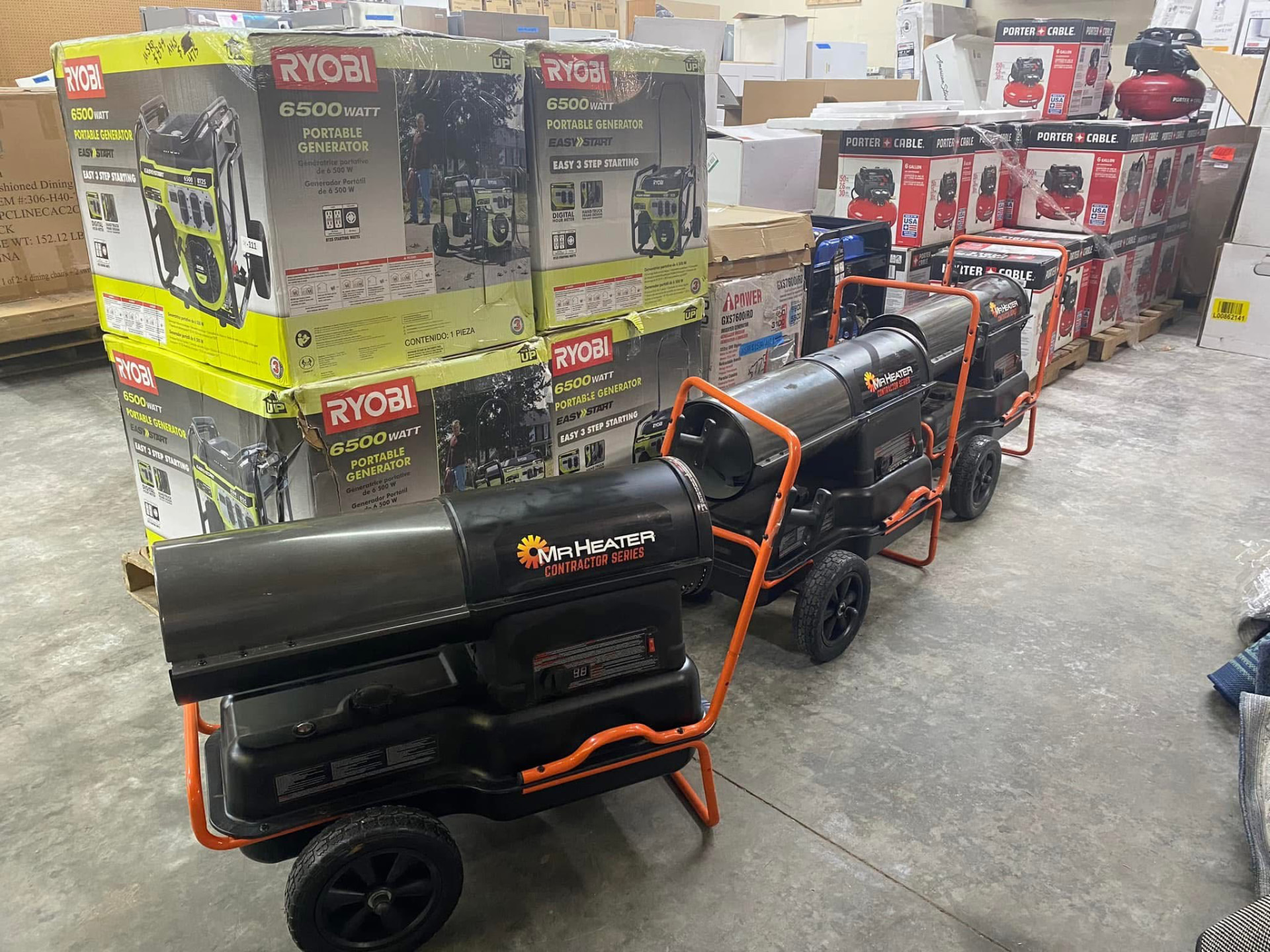 Boxed Ryobi portable generators beside Mr. Heater contractor series forced-air heaters on the warehouse floor