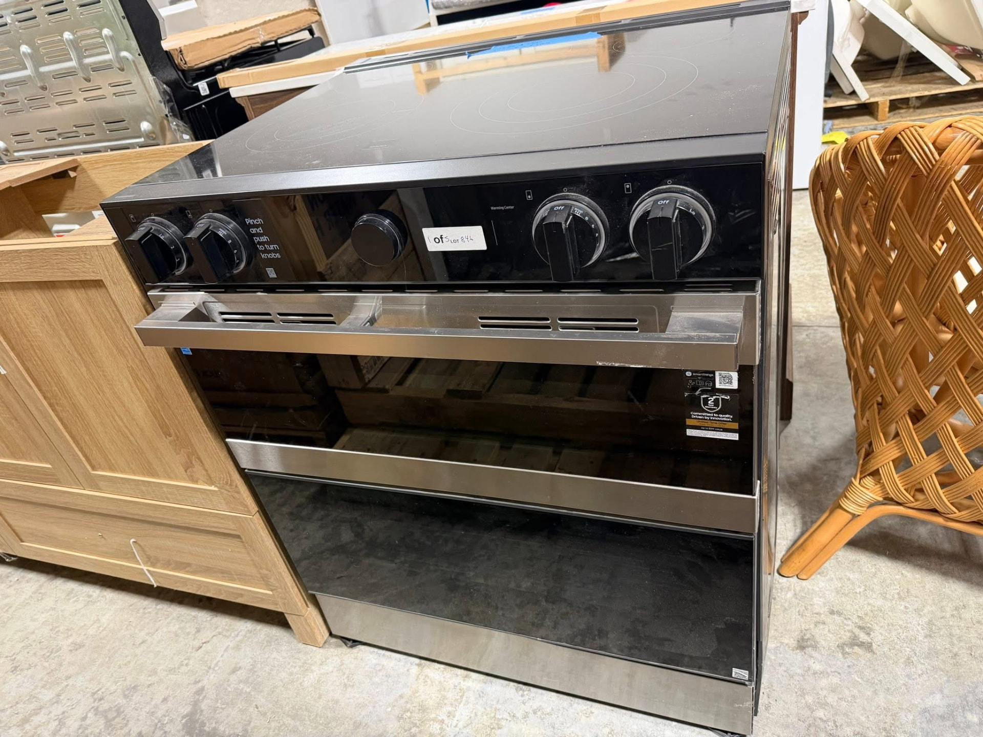 Stainless steel electric range with a black glass cooktop on the sales floor at Austin's Home Supply & More